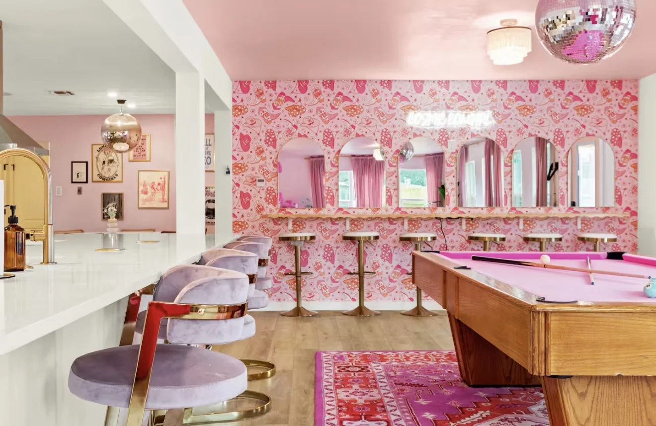 Airbnb game room with pink pool table