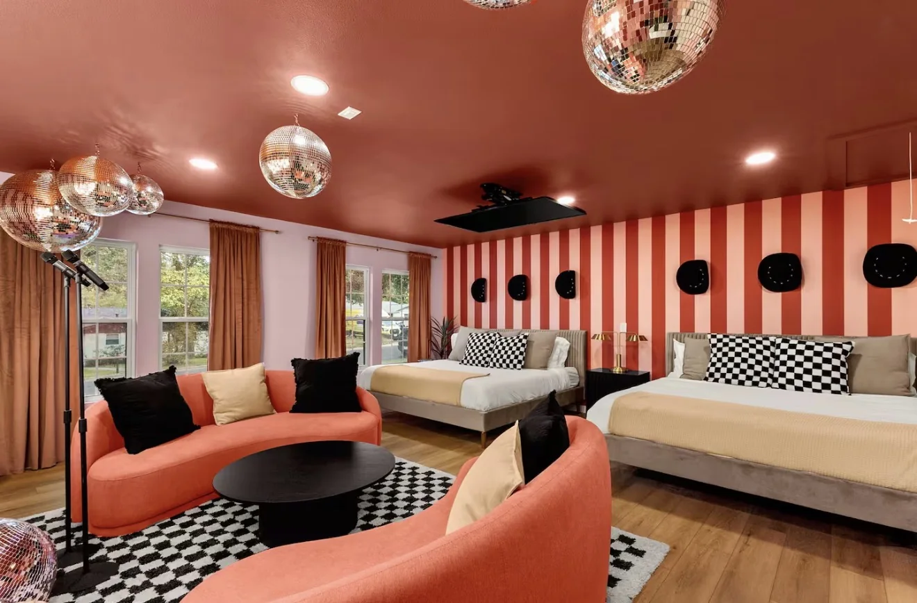 Airbnb room with striped wall and disco balls